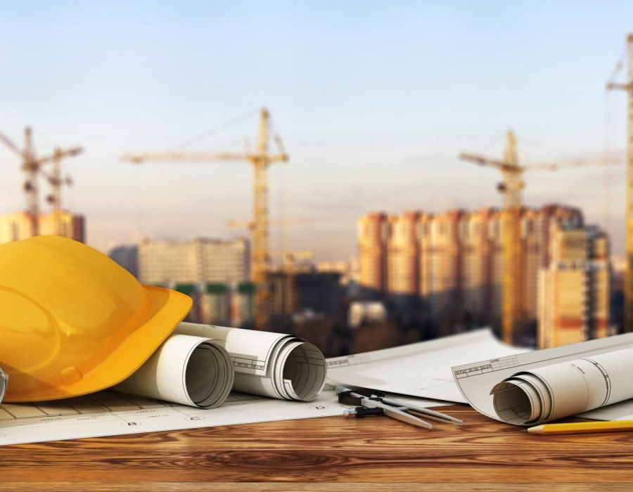 Concept of construction and design. 3d render of blueprints and designer tools on the panorama of construction site.